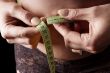 woman measure belly with tape