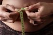 woman measure belly with tape