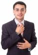 adjusting his tie