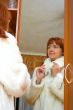 woman tries on a fur coat
