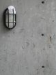 outdoor light with snow on a cement wall