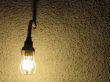 lit lightbulb in front of a wall