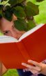 woman with book under the tree