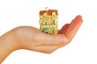  womanish hand holds a toy cottage