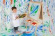 Little boy playing with painting