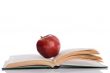 Red apple with open book and reflection