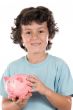 Adorable boy with pink piggy bank
