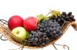 Bunches of grapes and apples in basket.