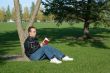 Man Reading By A Tree