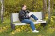 Man Reading on a Bench