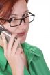 Redheaded girl talking on a mobile phone