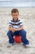 Beautiful boy sitting on a ball on the beach
Beautiful boy sitti