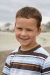 Pretty boy smiling on beach