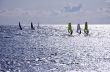 Seven windsurfers are at the Mediterranean Sea