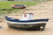 Boat and little fishing ship on the sand with low tide