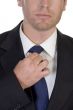 young businessman fastening his tie