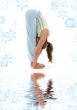 uttanasana standing forward bend on white sand