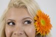 lady with flower in hair looking askance