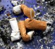 Four smoked cigarettes in a dirty ashtray