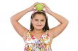 Adorable girl with flowered dress with a apple
