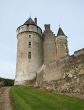 The medieval French castle standing on a grief, against the sky
