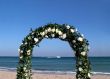 Arc of flowers during a wedding at the sea