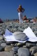 On a beach a paper under stones