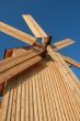 Rural wooden windmill against blue sky