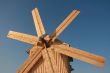 Rural wooden windmill against blue sky