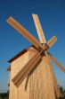 Rural wooden windmill against blue sky