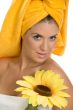 posing smiling sexy female in towel with sunflower