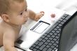 cute baby playing with laptop