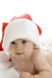 smiling toddler wearing red christmas cap