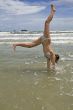 female teenager jumps on the beach
