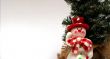 Christmas card with a snowman and christmas-tree