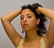 Latina with hands in hair