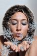 Beautiful woman blowing snow