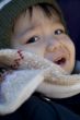 small child with scarf and hood