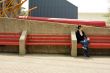 Woman on red bench