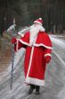 Santa Claus coming along deep forest road