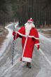 Santa Claus coming along deep forest road