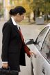 businesswoman opens a car door
