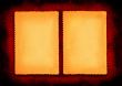 two pieces of yellowed paper on red