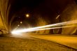 lone car moving fast in tunnel