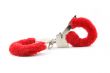 closed red handcuffs isolated on white background