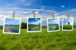Landscape photographs hanging on a clothesline