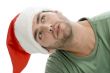 man with santa cap and looking upward