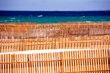 Wooden fence on deserted beach dunes