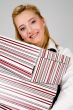 Smiling young woman with stack of boxes