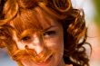 Bright portrait of red-haired young woman outdoors